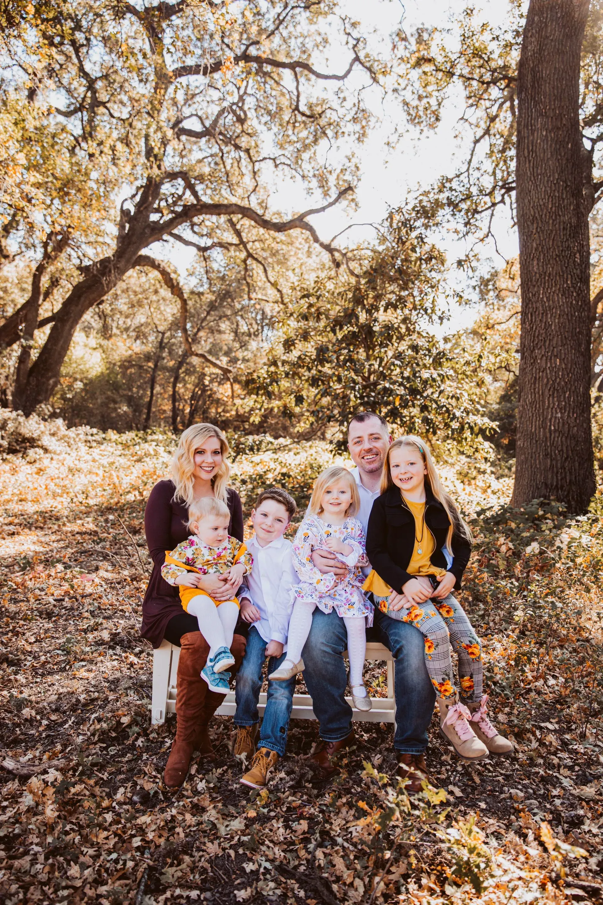 With Julie and their four children, the family Mark calls home. Mark C. Smith with his wife Julie and their four children, photographed outdoors among California oak trees.