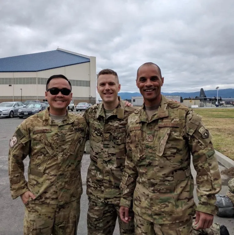 With fellow airmen. Seth Steward in uniform alongside two members of his California Air National Guard unit outside a hangar.