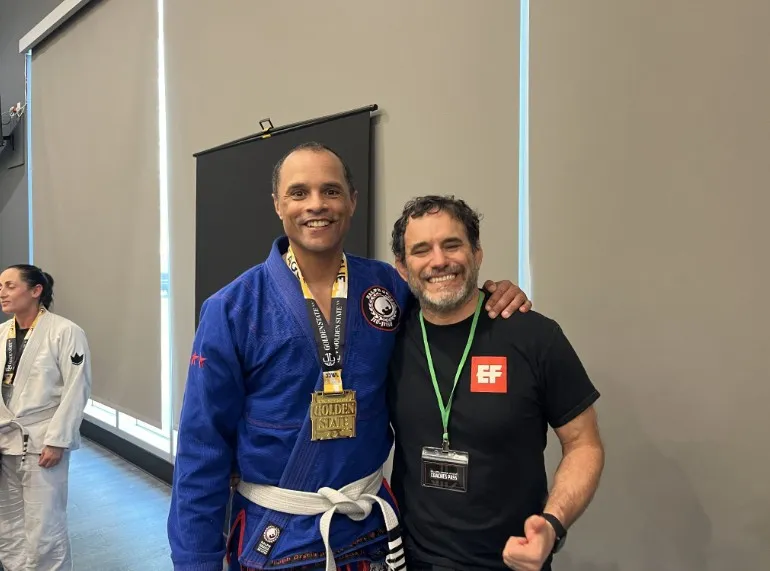 Discipline off duty. Seth Steward in a blue gi with a tournament medal after a Brazilian jiu-jitsu competition.